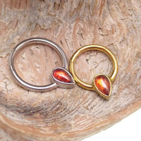 Magpie 16g natural stone garnet titanium clicker with 8mm gemstone, showcasing the jewelry's vibrant red garnet and sleek titanium design.