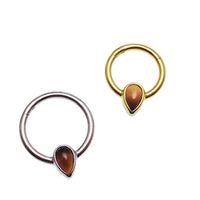 Natural stone Tigers Eye 16g titanium clicker earring with teardrop shape, designed by Magpie for stylish body jewelry.