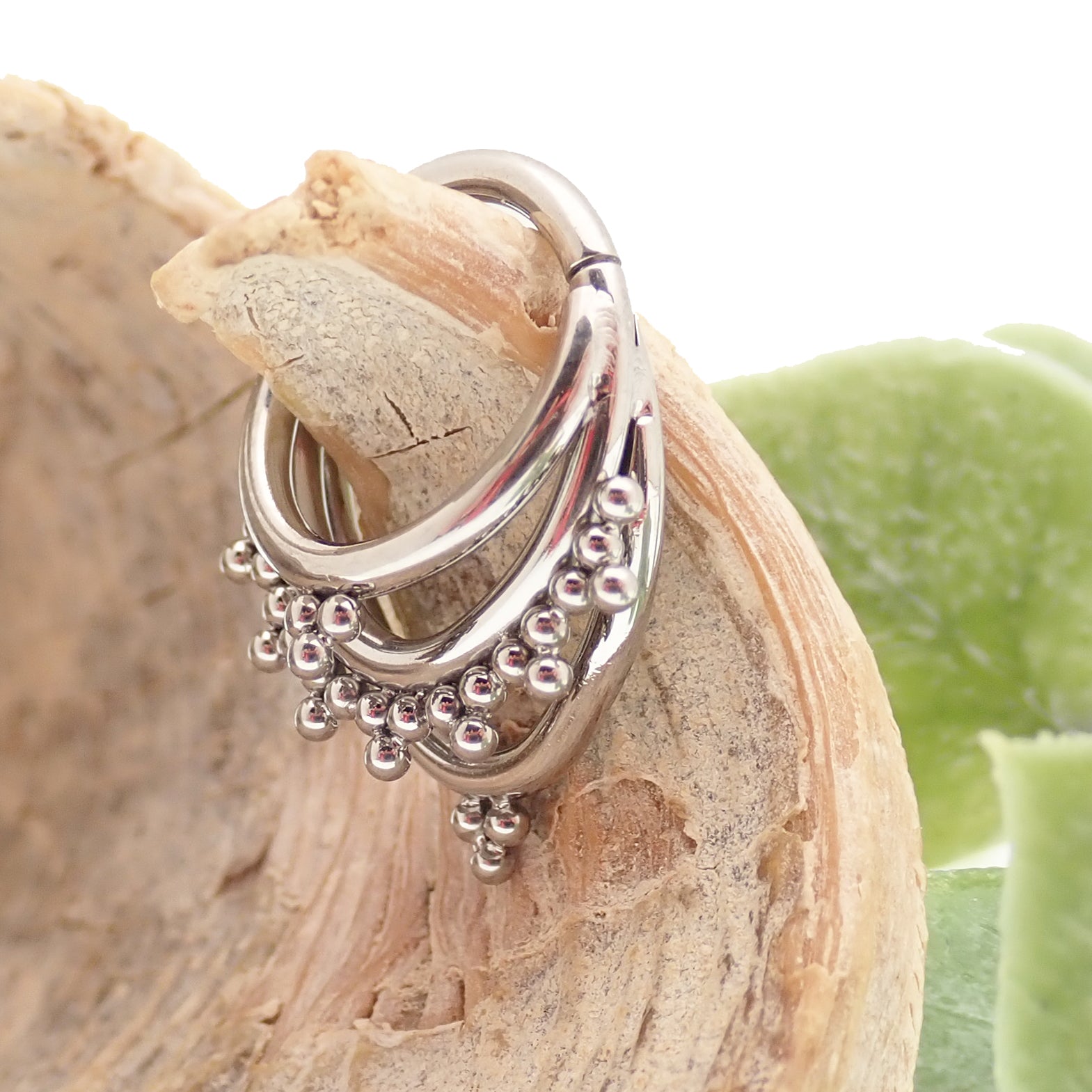 Magpie 16g titanium 3-tier fan-out septum clicker in 8mm and 10mm with beaded design, showcasing multiple stacked tiers.
