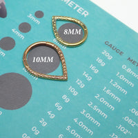Hammered V Titanium Clicker in 8mm and 10mm sizes by Magpie, featuring textured hammered finish and sleek V-shaped design.