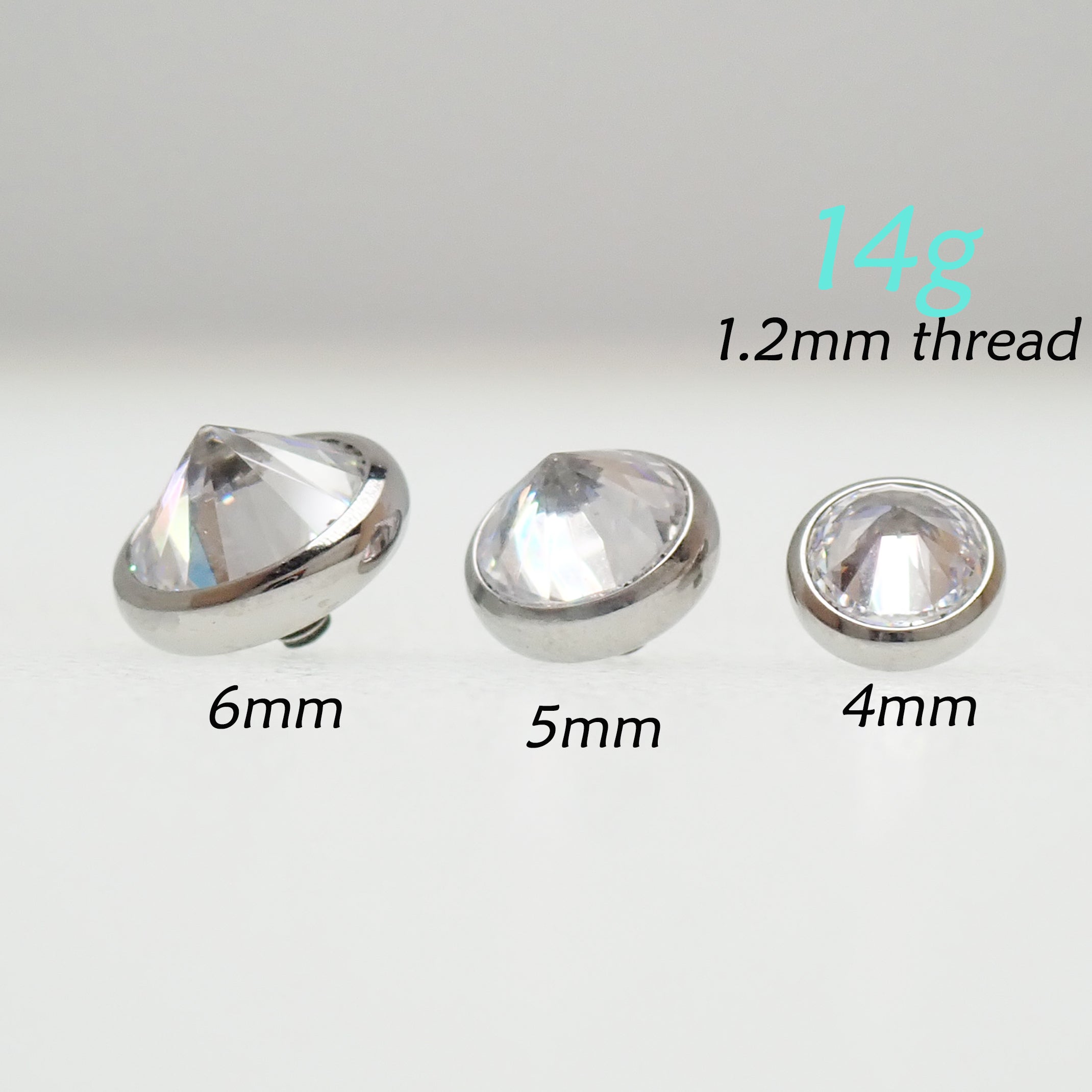 Magpie internally threaded 14g CZ top attachment with 1.2mm thread, displayed on a jewelry display.