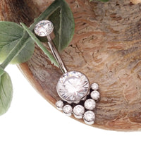 Magpie CZ titanium belly ring, 10mm to 12mm, featuring a sparkling cubic zirconia stone and a sleek, curved design.