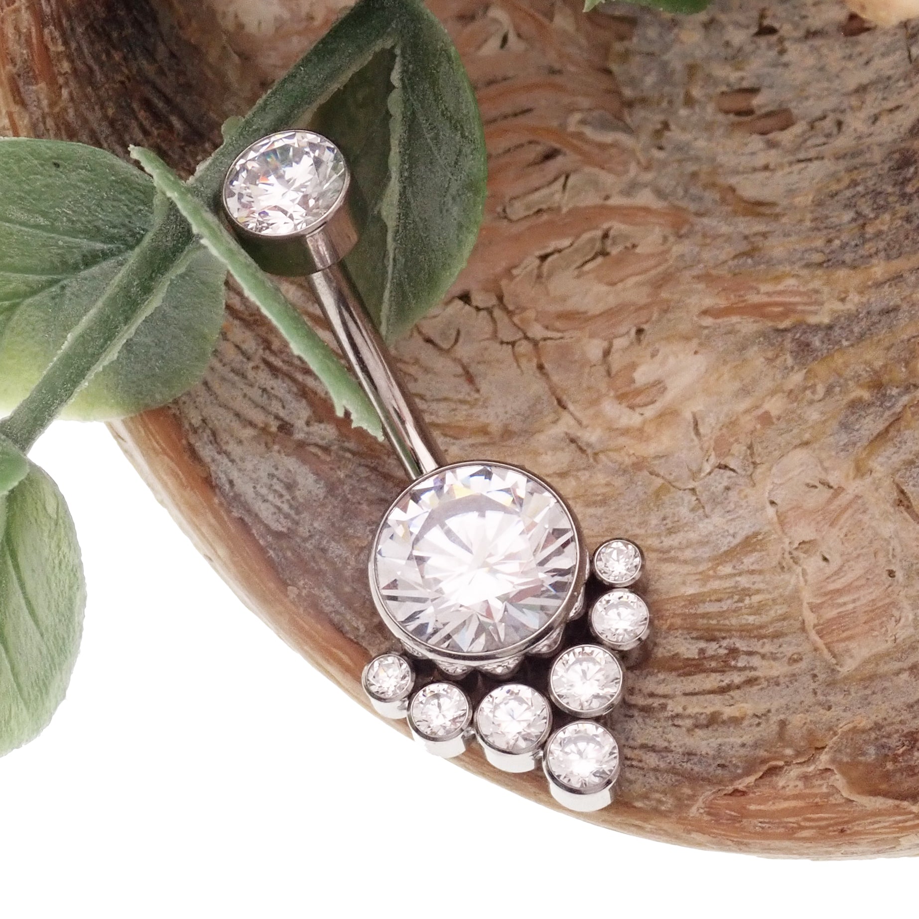 Magpie CZ titanium belly ring, 10mm to 12mm, featuring a sparkling cubic zirconia stone and a sleek, curved design.