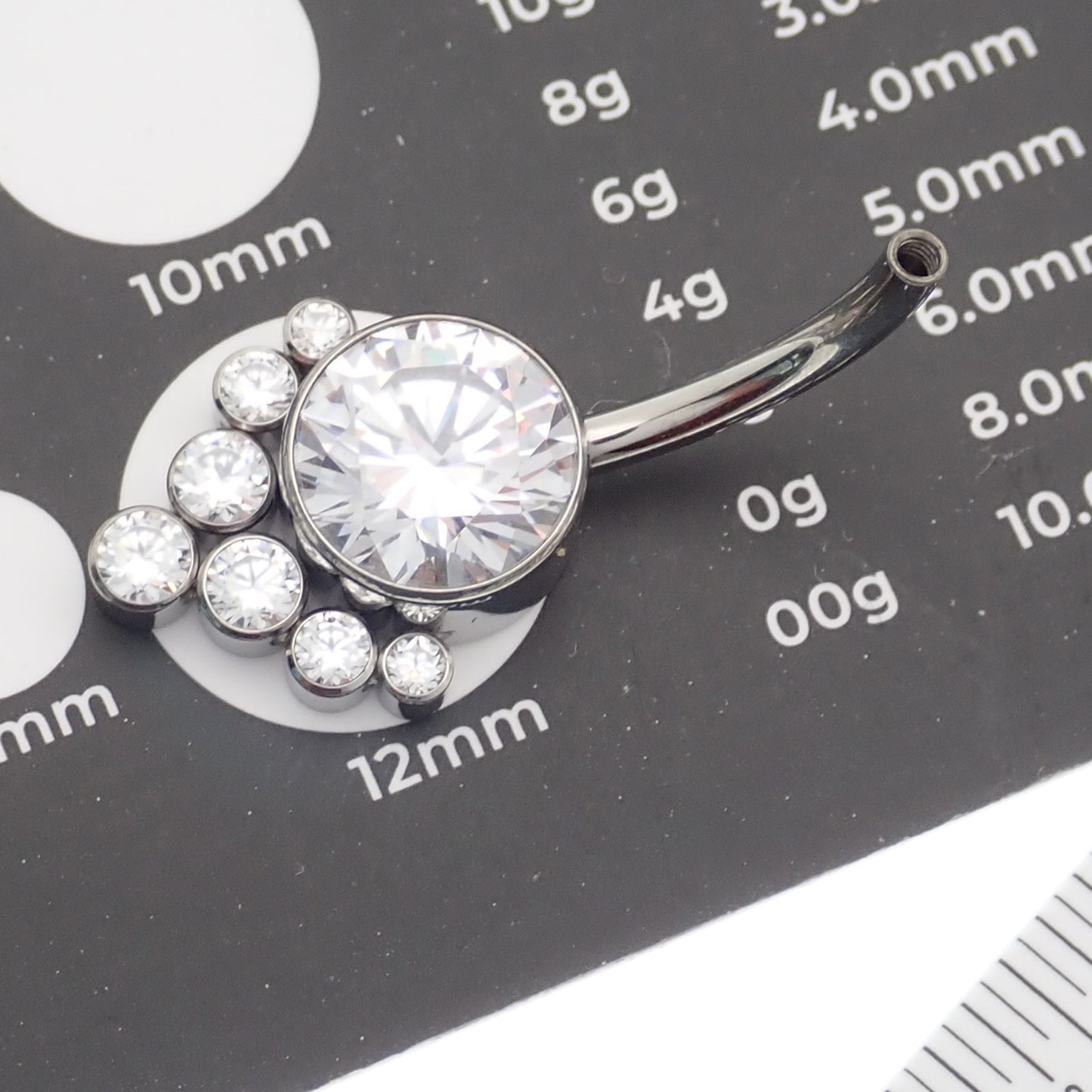 Magpie CZ titanium belly ring, 10mm to 12mm, with sparkling cubic zirconia accents, displayed on a plain background