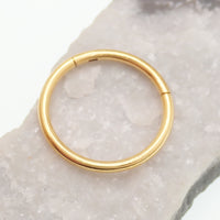Gold PVD titanium clicker hoop by Magpie Body Jewelry, 18g and 16g, featuring a simple, sleek design with a 7mm diameter.