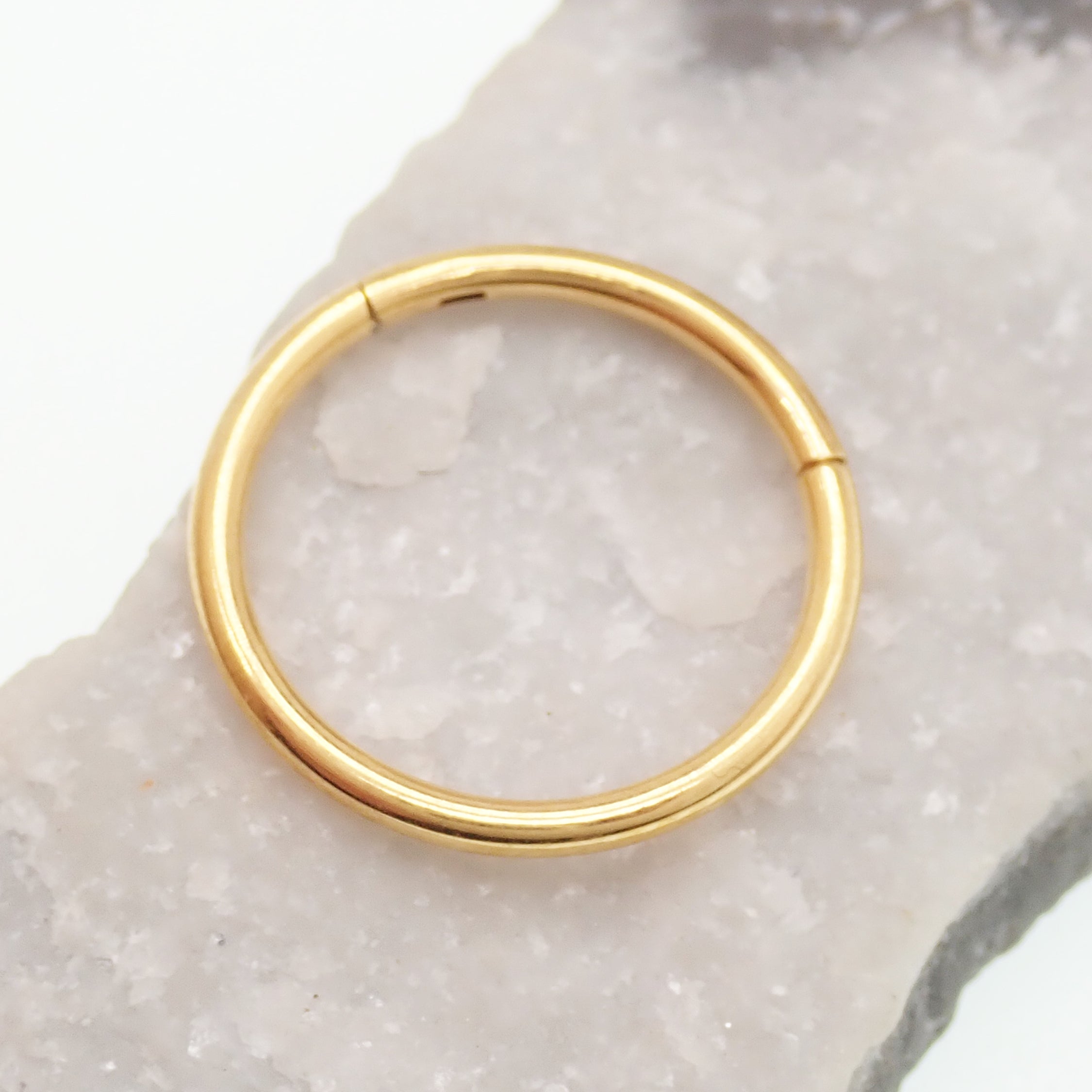 Gold PVD titanium clicker hoop by Magpie Body Jewelry, 18g and 16g, featuring a simple, sleek design with a 7mm diameter.