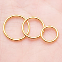Plain titanium PVD gold clicker hoop earring by Magpie Body Jewelry, 18g with 7mm diameter, suitable for cartilage or ear piercing.