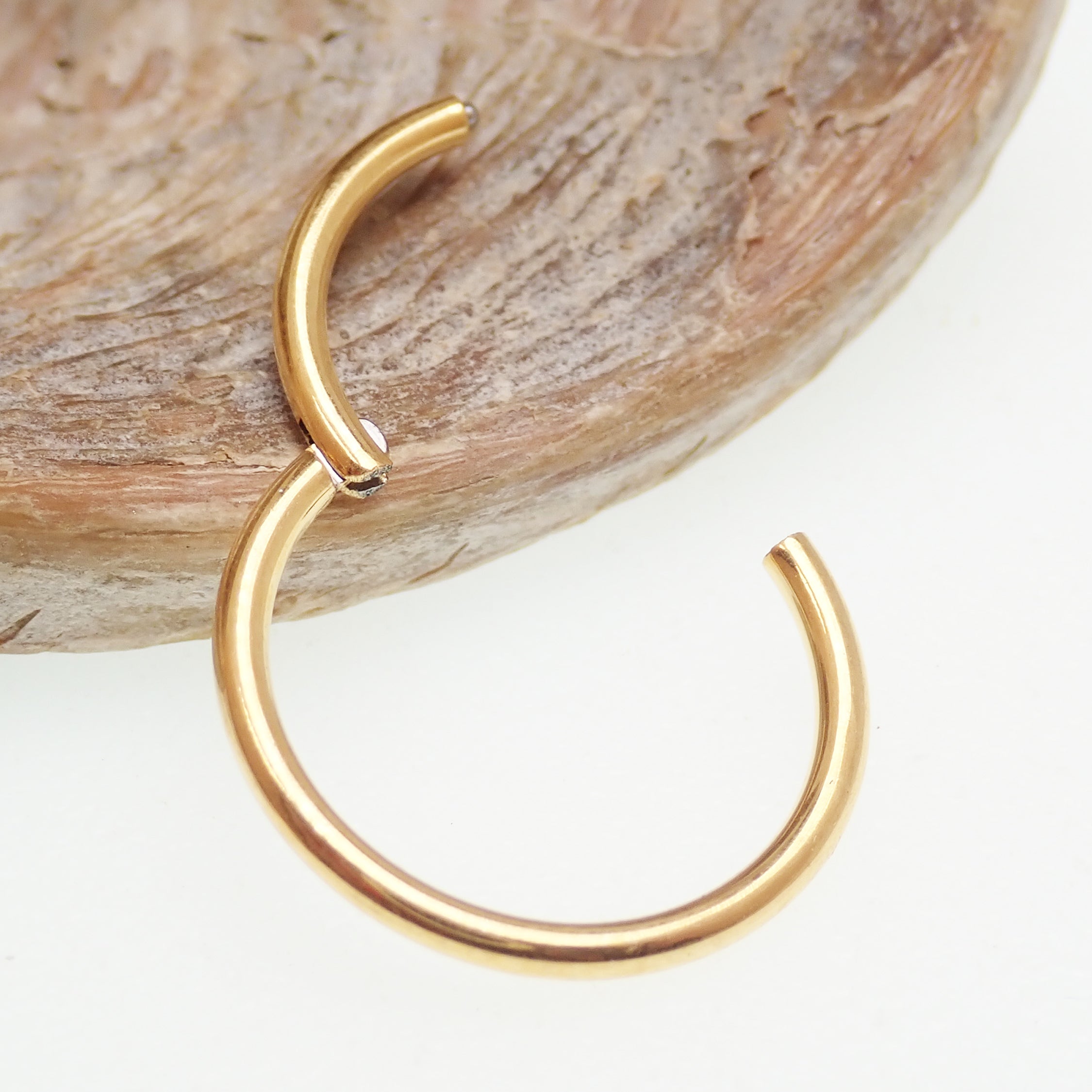 Plain titanium PVD gold clicker hoop earrings in 18g and 16g, featuring a sleek, minimalist design for body jewelry piercing.