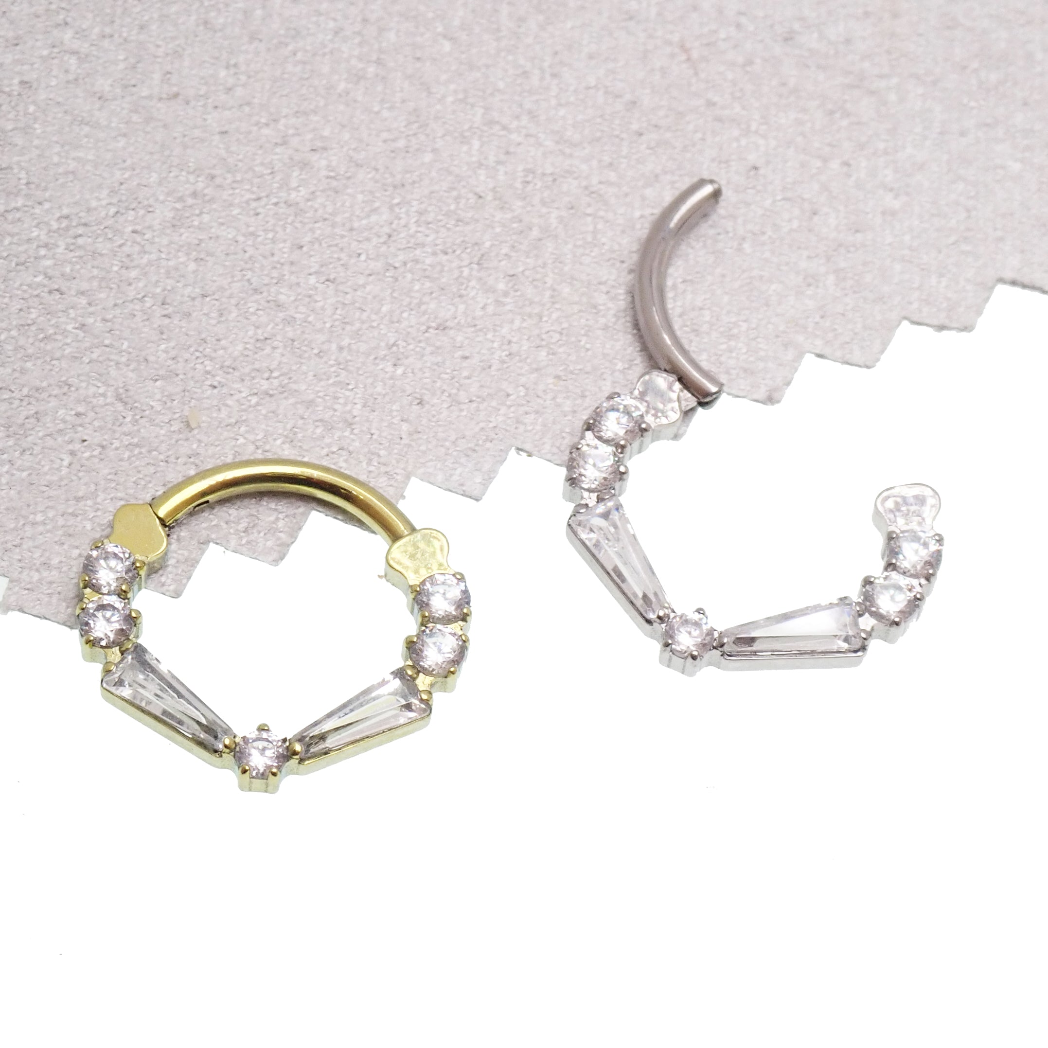 Clear titanium 16g taper baguette clicker with cubic zirconia stones, designed for body jewelry piercings.