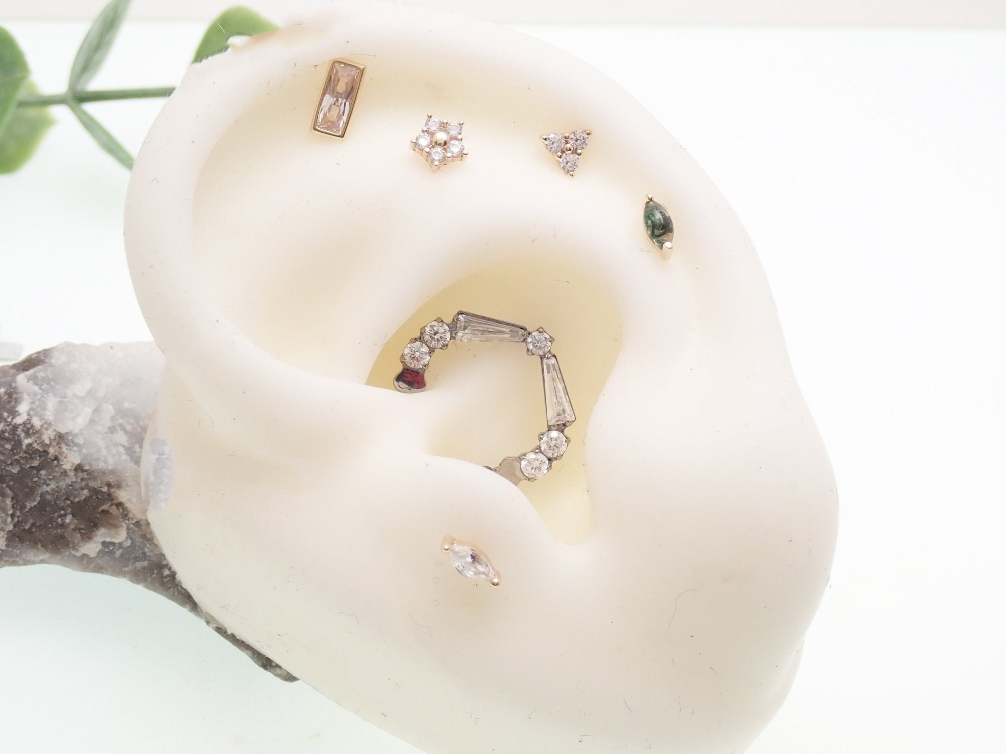 Clear titanium 16g taper baguette clicker with cubic zirconia, designed for body jewelry piercings by Magpie Body Jewelry.
