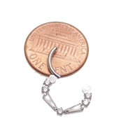 Clear titanium 16g taper baguette clicker with cubic zirconia stones, designed for body jewelry piercings by Magpie Body Jewelry.