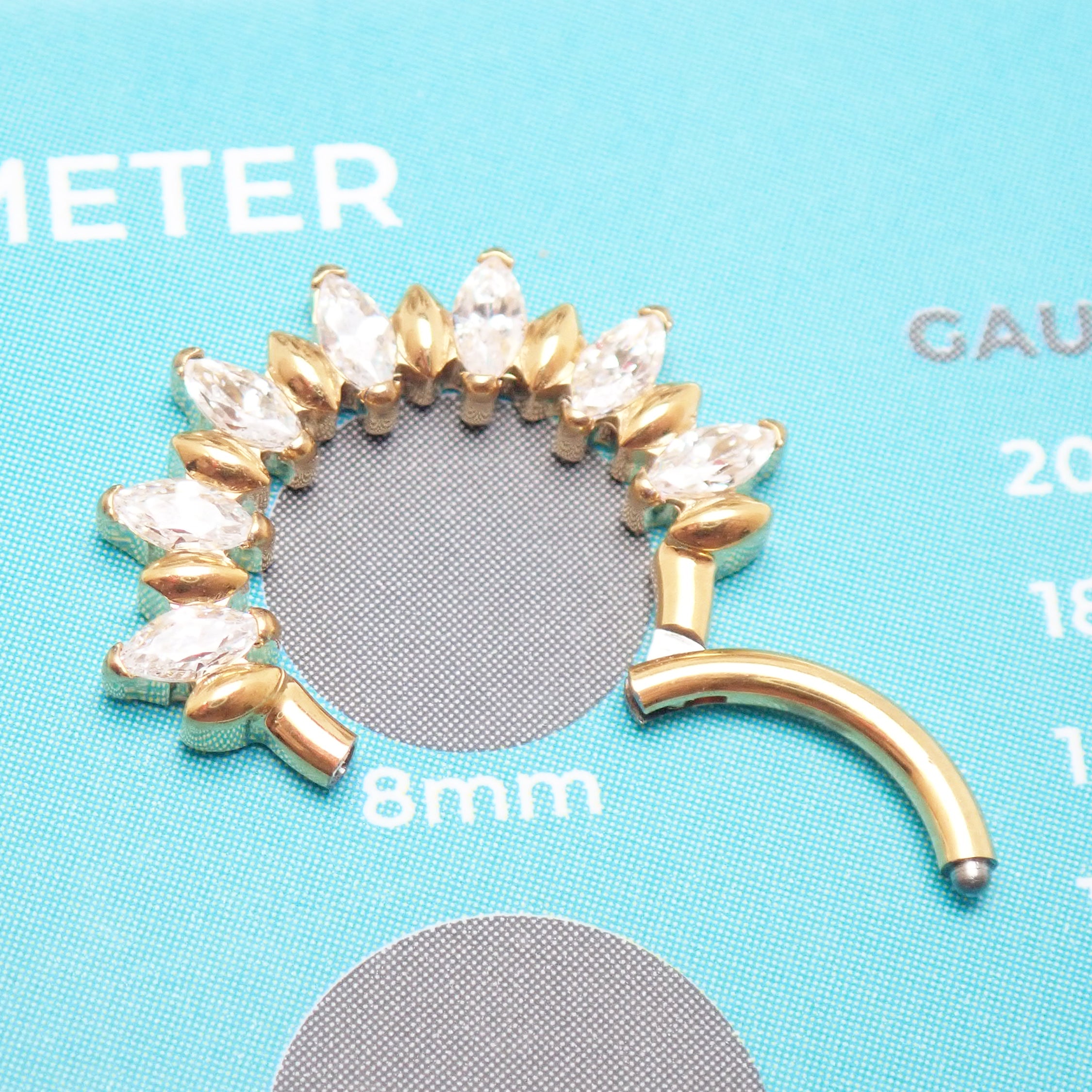 Gold PVD titanium clicker hoop with CZ stones, 16G 8mm size, showcasing a stylish and secure body jewelry piece.