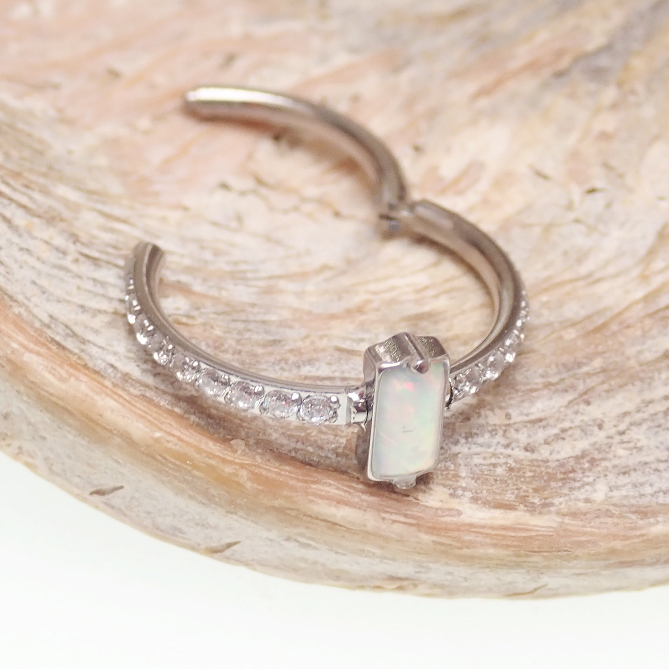 Rectangular white opal CZ titanium clicker jewelry in 16g, 11mm size, by Magpie Body Jewelry, shown on a clean background.