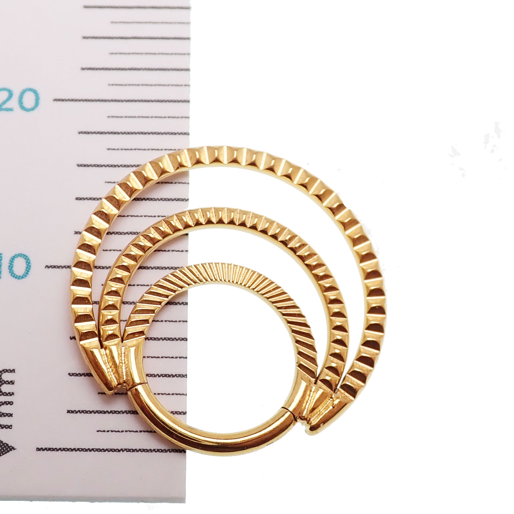 Titanium triple clicker hoop with 24k PVD gold or polished finish, 16G septum and daith jewelry by Magpie Body Jewelry.
