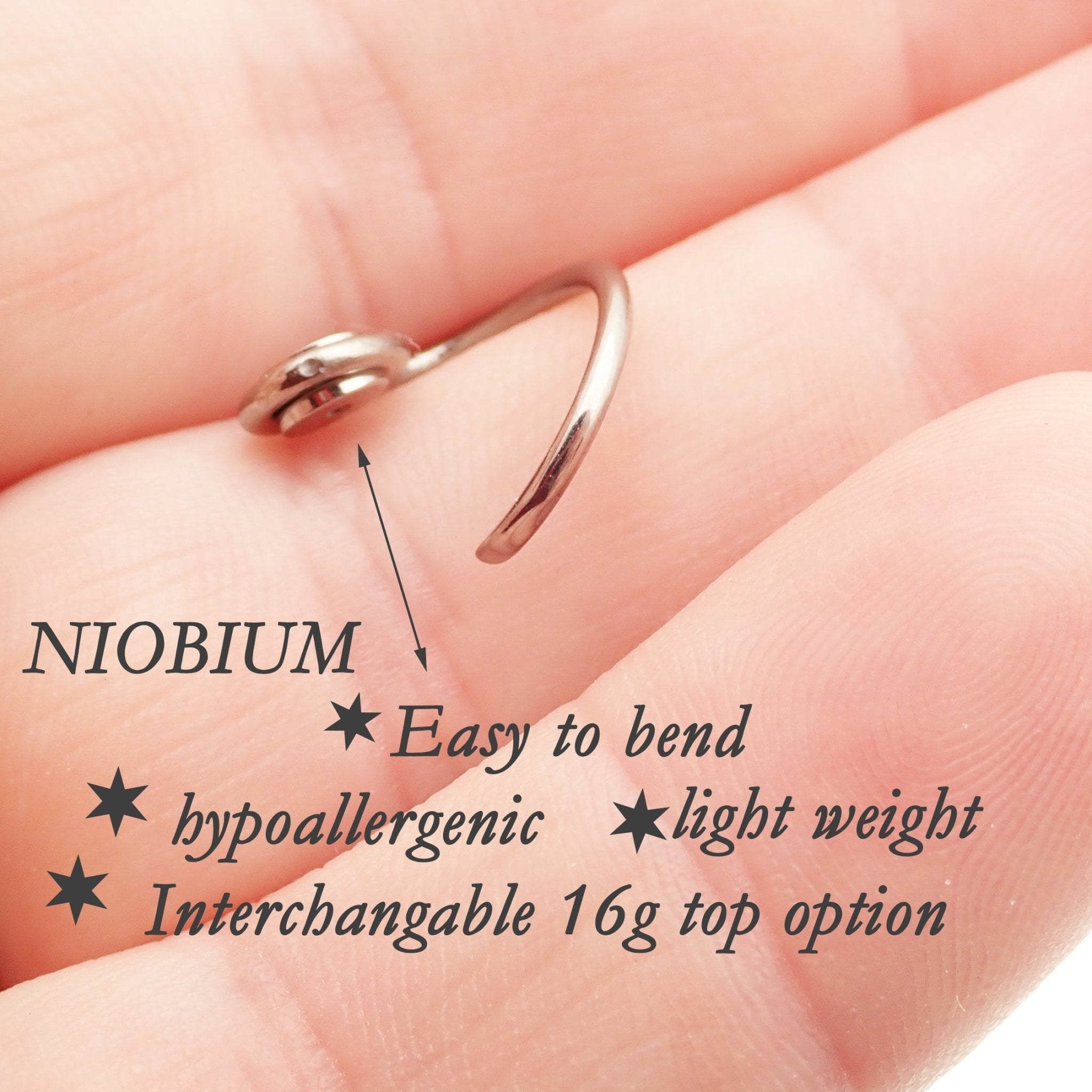 Niobium daith spiral body jewelry in 16g with customizable top design, by Magpie, featuring a sleek spiral shape and smooth finish.