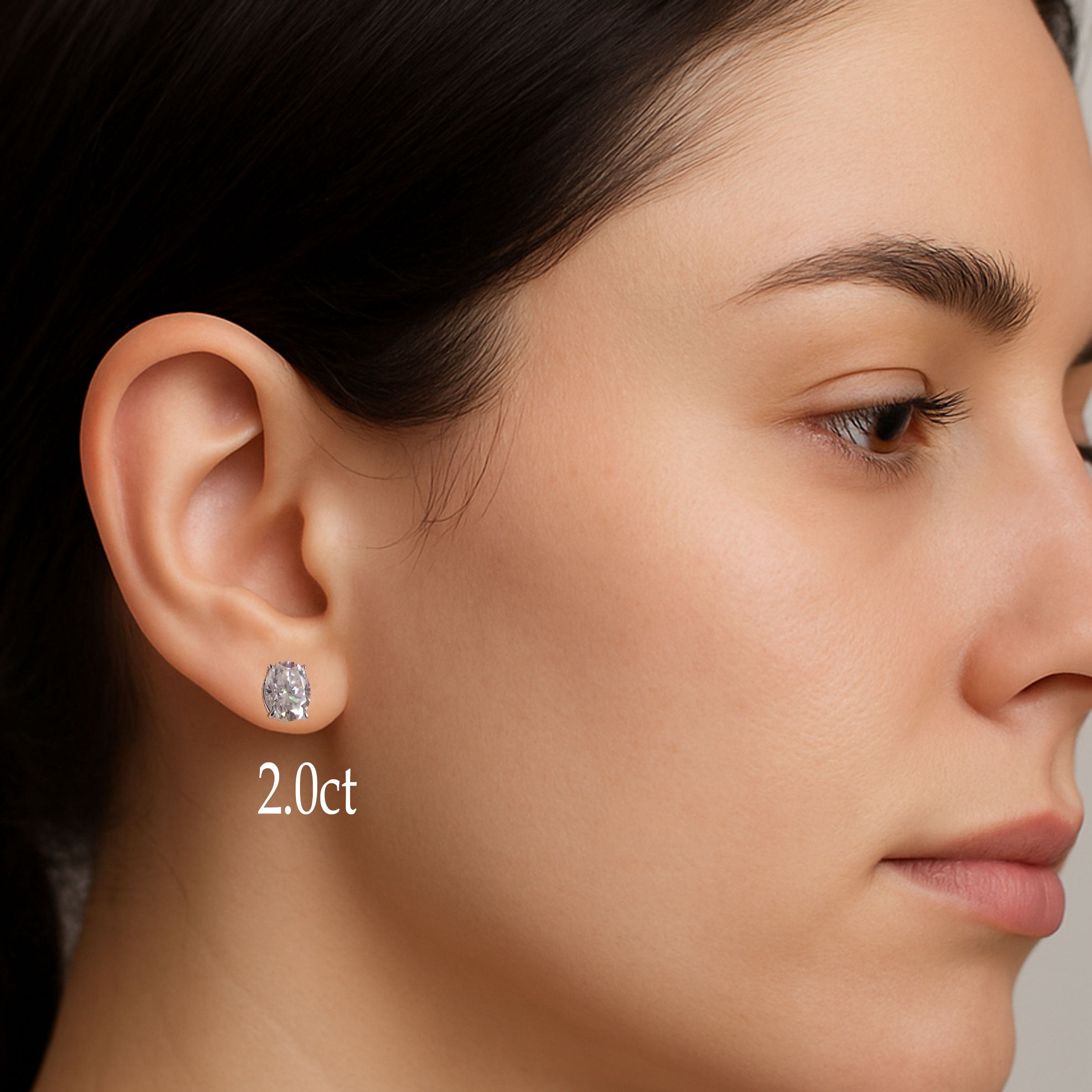 Sterling silver oval moissanite earrings with certificate, featuring 5x7mm oval-shaped stones from Magpie Body Jewelry.