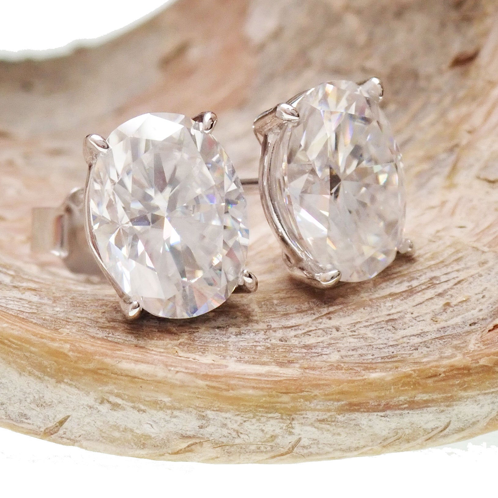 Sterling silver Moissanite oval earrings with certificate, featuring 5x7mm sparkling gemstones and elegant dangle design.