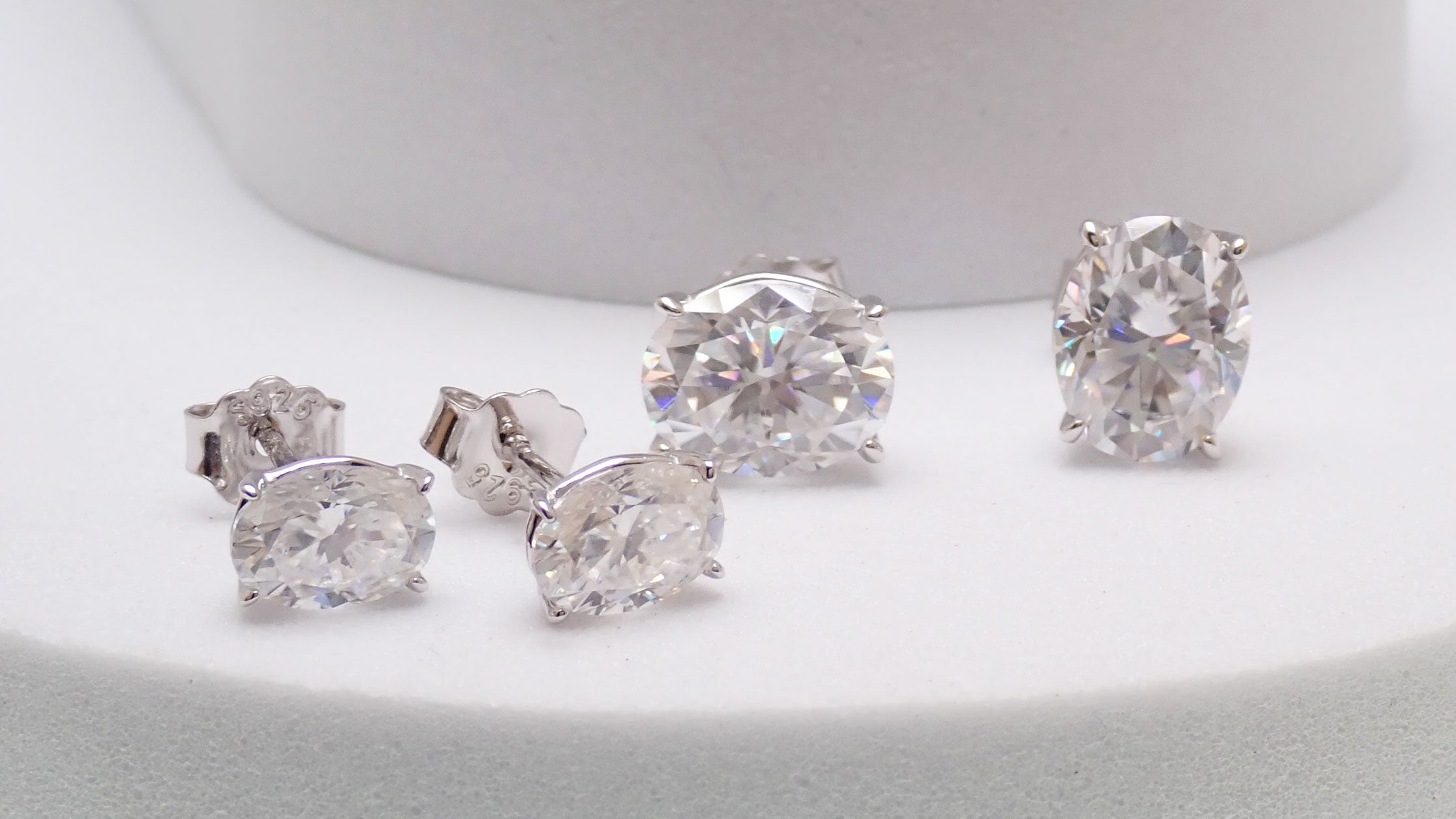 Sterling silver moissanite oval earrings with certificate, 5x7mm size, elegant jewelry by Magpie Body Jewelry.