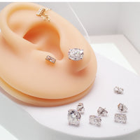 Sterling silver moissanite oval earrings with certification, 5x7mm size, featuring sparkling gemstone and elegant design.