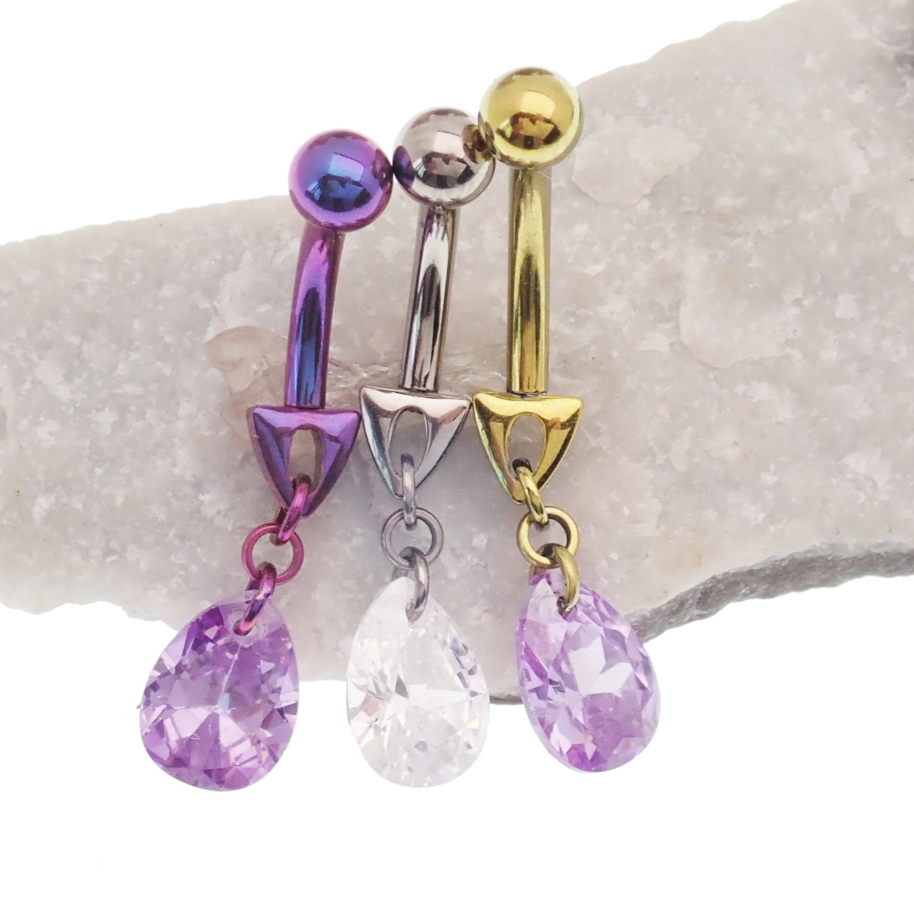 Magpie 14g violet curve bar belly ring with cute dangle design, showcasing the curved bar and decorative dangle element.