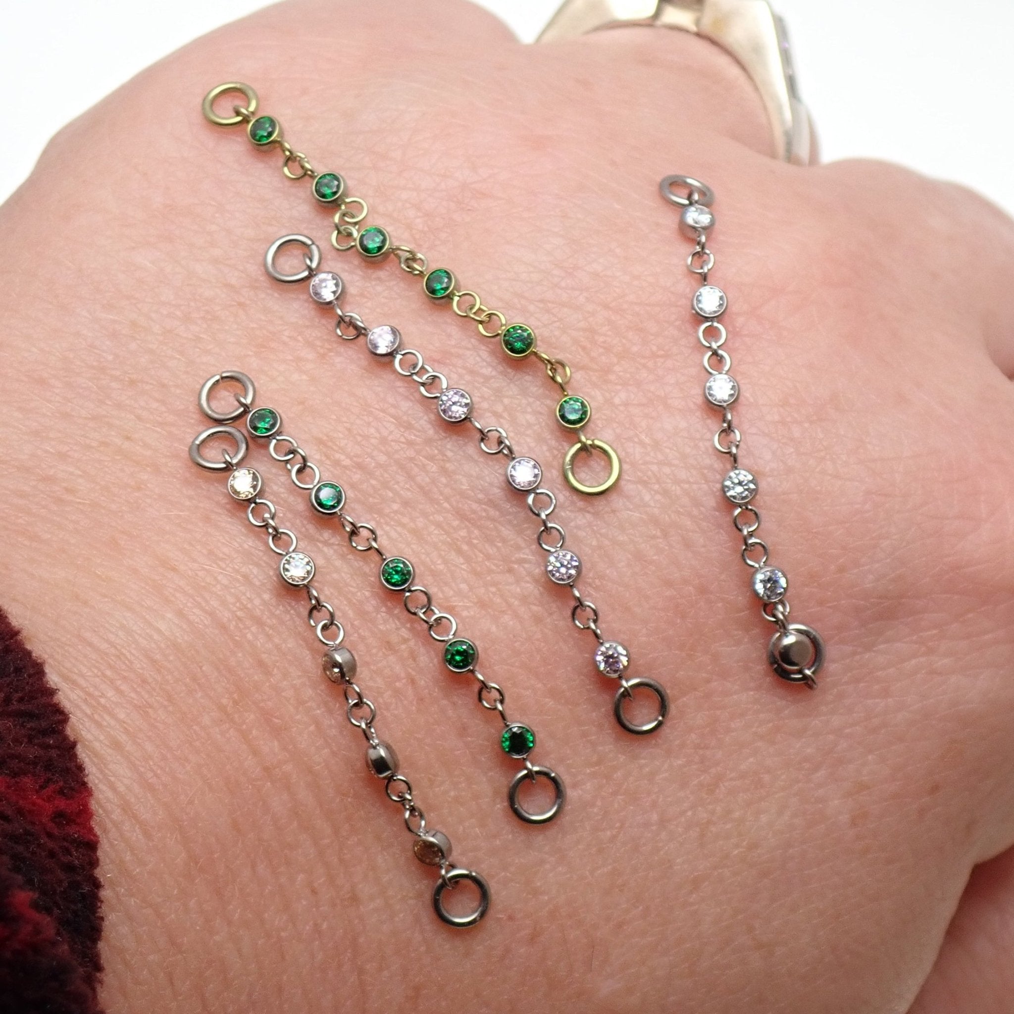 Magpie titanium and CZ ear cuff chain with emerald accents, 32mm or 38mm add-on piercing chain for stylish ear jewelry.