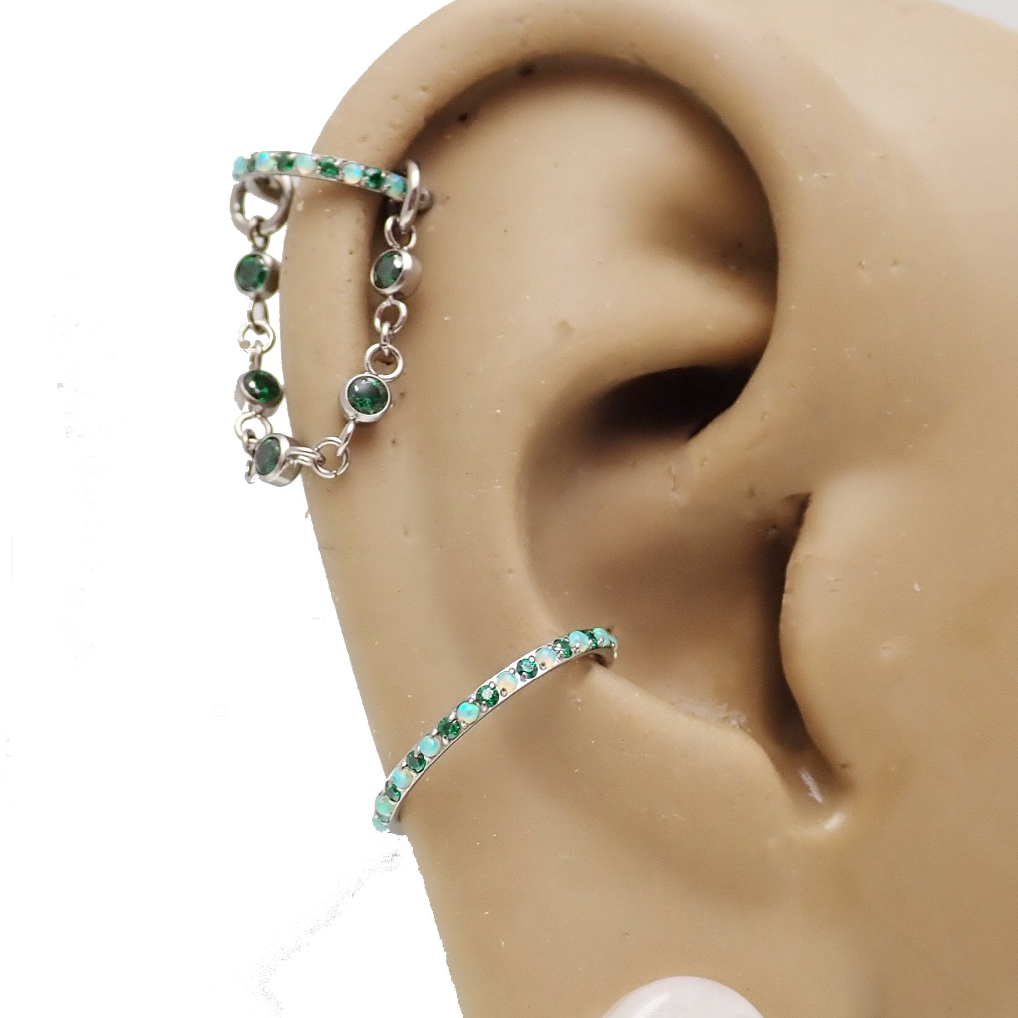 Magpie titanium and cubic zirconia ear cuff chain with emerald accents, available in 32mm or 38mm add-on piercing chain.