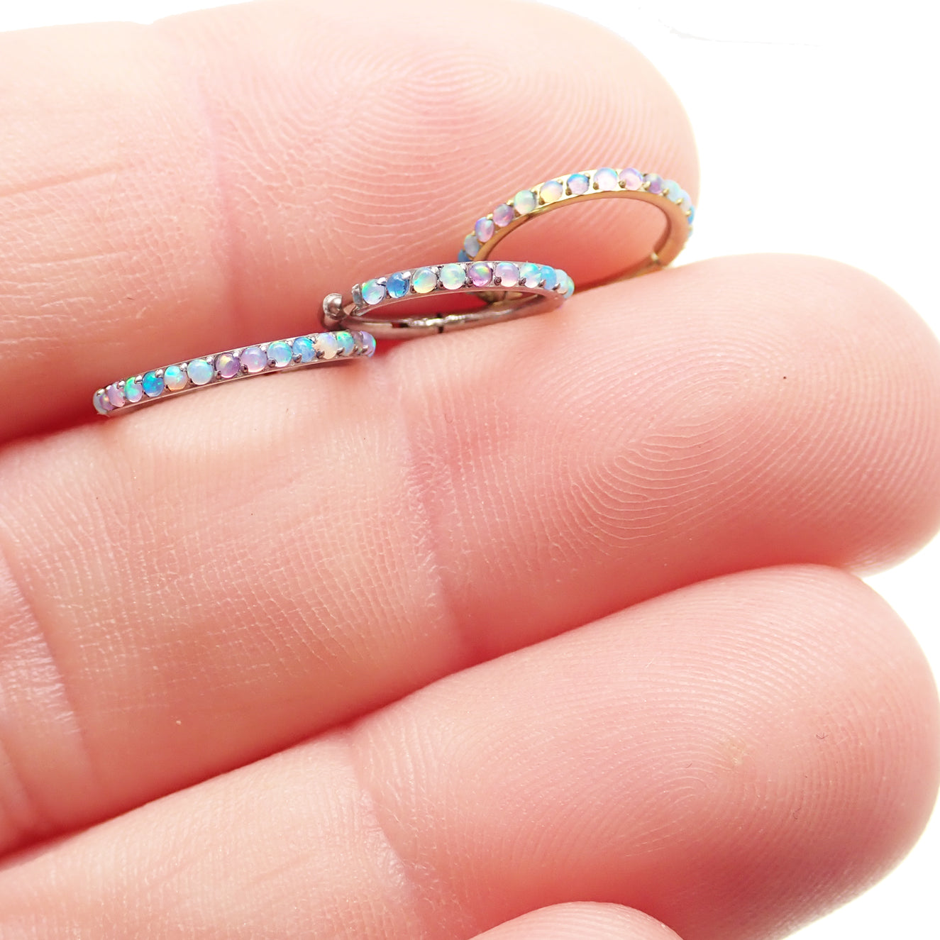 Magpie pastel opal titanium hinged clicker in 16g/18g with side-facing design for body piercing jewelry.