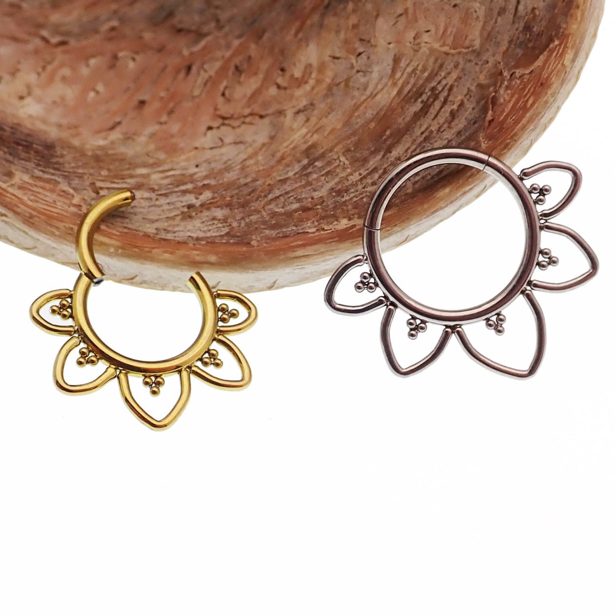Plain filigree titanium hinged clicker earring in 16g from Magpie, featuring intricate metalwork and an open design.