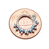 Magpie 16g titanium sunburst CZ hinged clicker with 8mm and 10mm sizes, displayed on a penny, showcasing vibrant design and jewelry detail.
