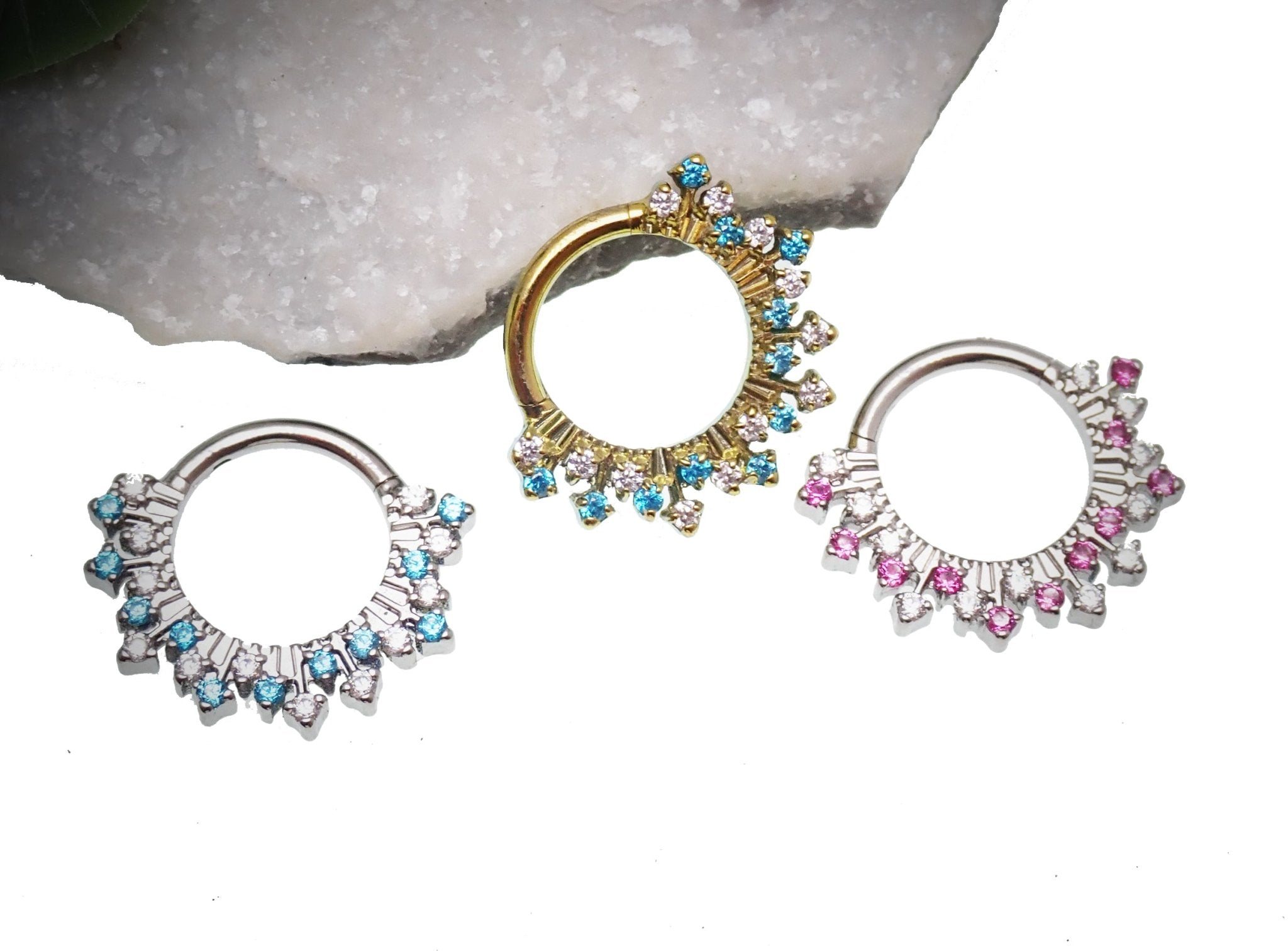 Magpie 16g titanium sunburst CZ hinged clicker piercing with 8mm and 10mm sizes, featuring a vibrant sunburst design.