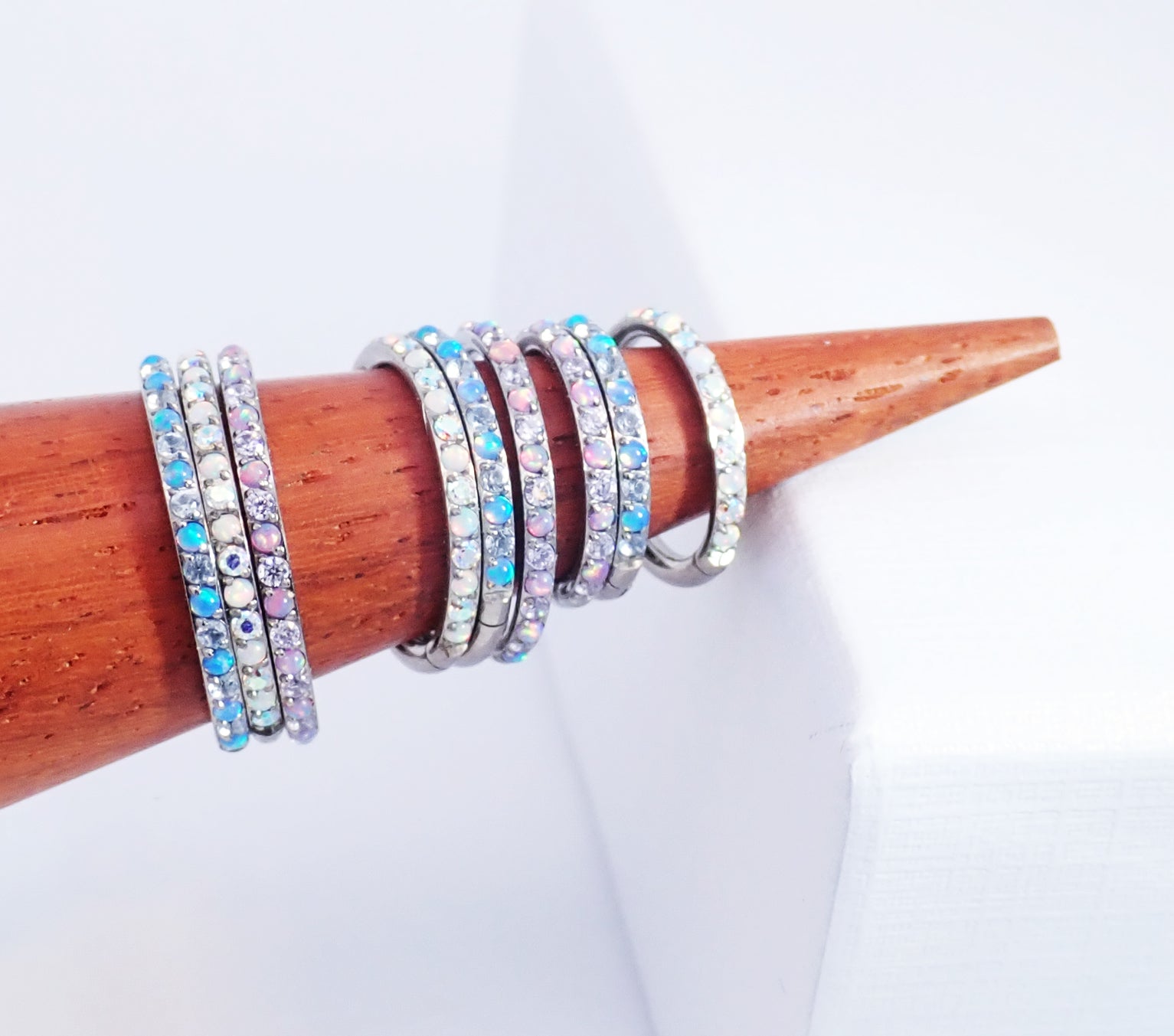 Magpie 16g titanium hinged clicker hoop with opal and cubic zirconia stones in 8, 10, or 12mm sizes, showcasing a secure hinged design.