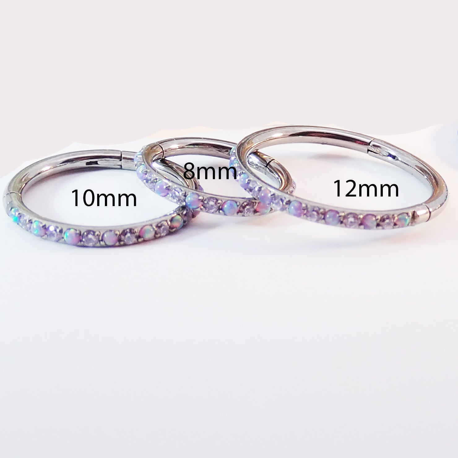 Magpie 16g titanium hinged clicker hoop with lavender opal and CZ stones, available in 8, 10, 12mm sizes.