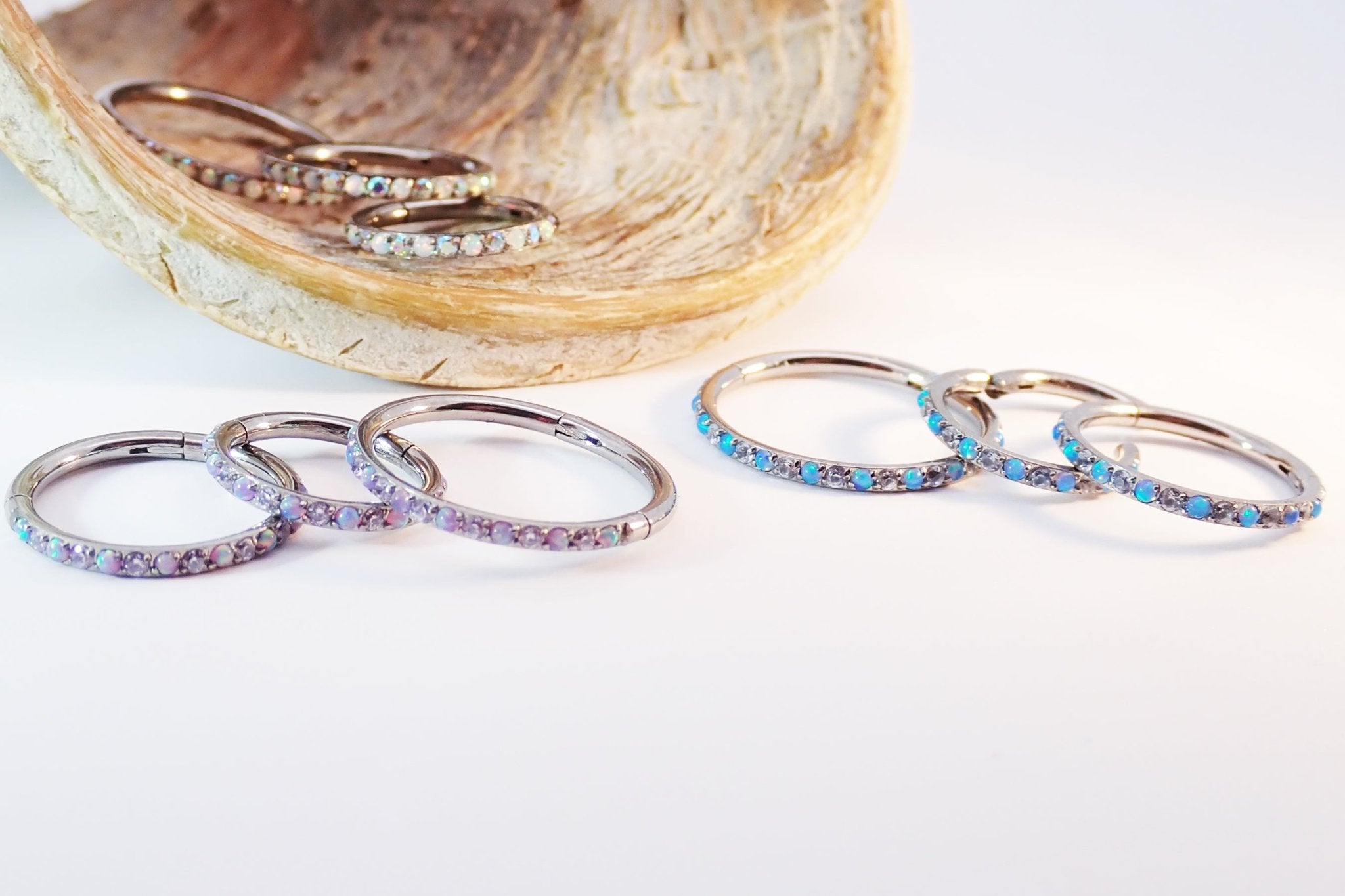 Titanium hinged clicker hoop with opal and cubic zirconia accents, available in 8mm, 10mm, and 12mm sizes.