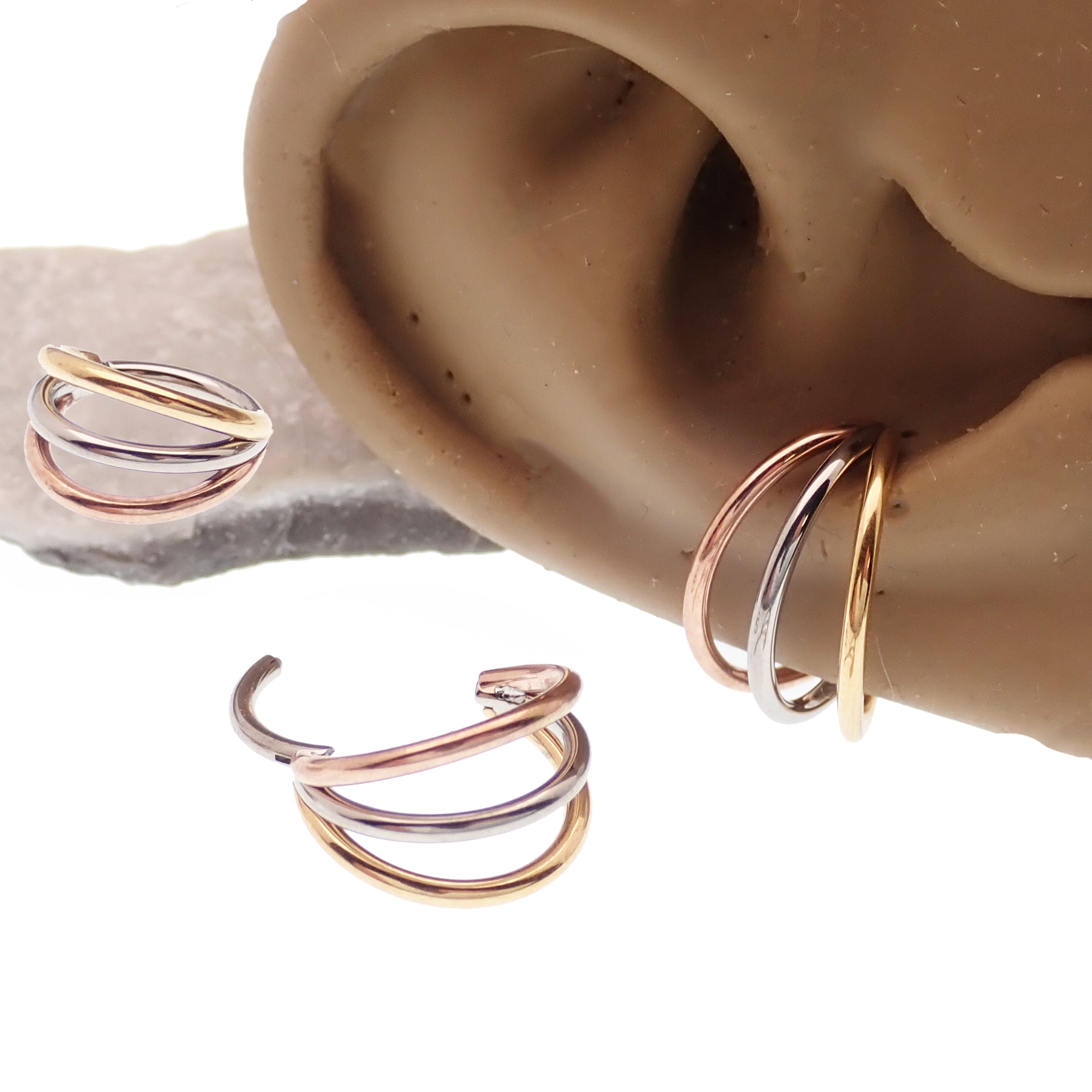 Magpie triple metal stacked titanium septum clicker with 8mm diameter, 16g gauge, featuring a sleek, layered design for body piercing.