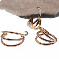 Magpie triple metal stacked titanium septum clicker with 8mm diameter, 16g gauge, featuring layered metal design.
