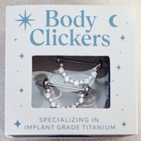 Internally threaded titanium CZ shield nipple ring barbell in 14mm and 16mm sizes, packaged for body jewelry.