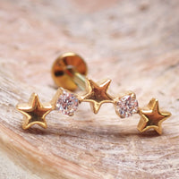 Star CZ PVD gold helix curve titanium flatback labret piercing earring on wood background, available in 14g, 16g, 18g.