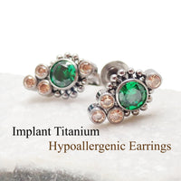 Titanium implant earrings with emerald and champagne-colored accents, 20g, showcasing sleek, modern jewelry design.