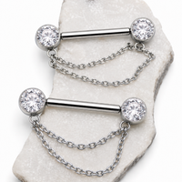 Silver barbell with chain and clear gemstones on a marble surface