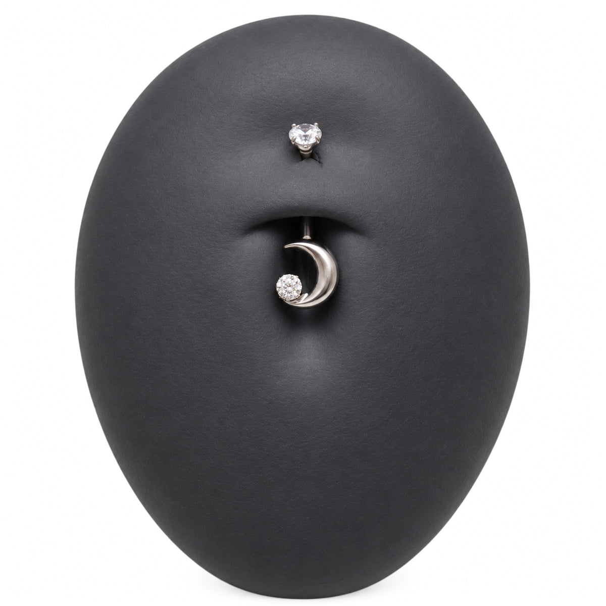 Moon CZ belly bar in a silicone belly button model
