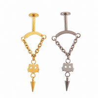 Silver and gold vertical helix piercings with a cat face silhouette and  a dangly cone charm, all connected by chains with a white background 