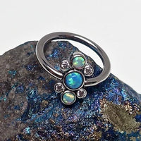 Titanium cluster blue opal closure ring by Body Clickers with 16g gauge and 10mm diameter, featuring a vibrant blue opal design.