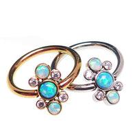 Titanium cluster blue opal closure ring by Body Clickers, 16g, 1-2mm thick, 10mm diameter, with vibrant blue opal stones.
