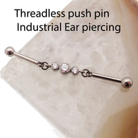 Industrial CZ piercing by Body Clickers with moveable titanium push pin, available in 14g and 16g gauges, with sparkling cubic zirconia.