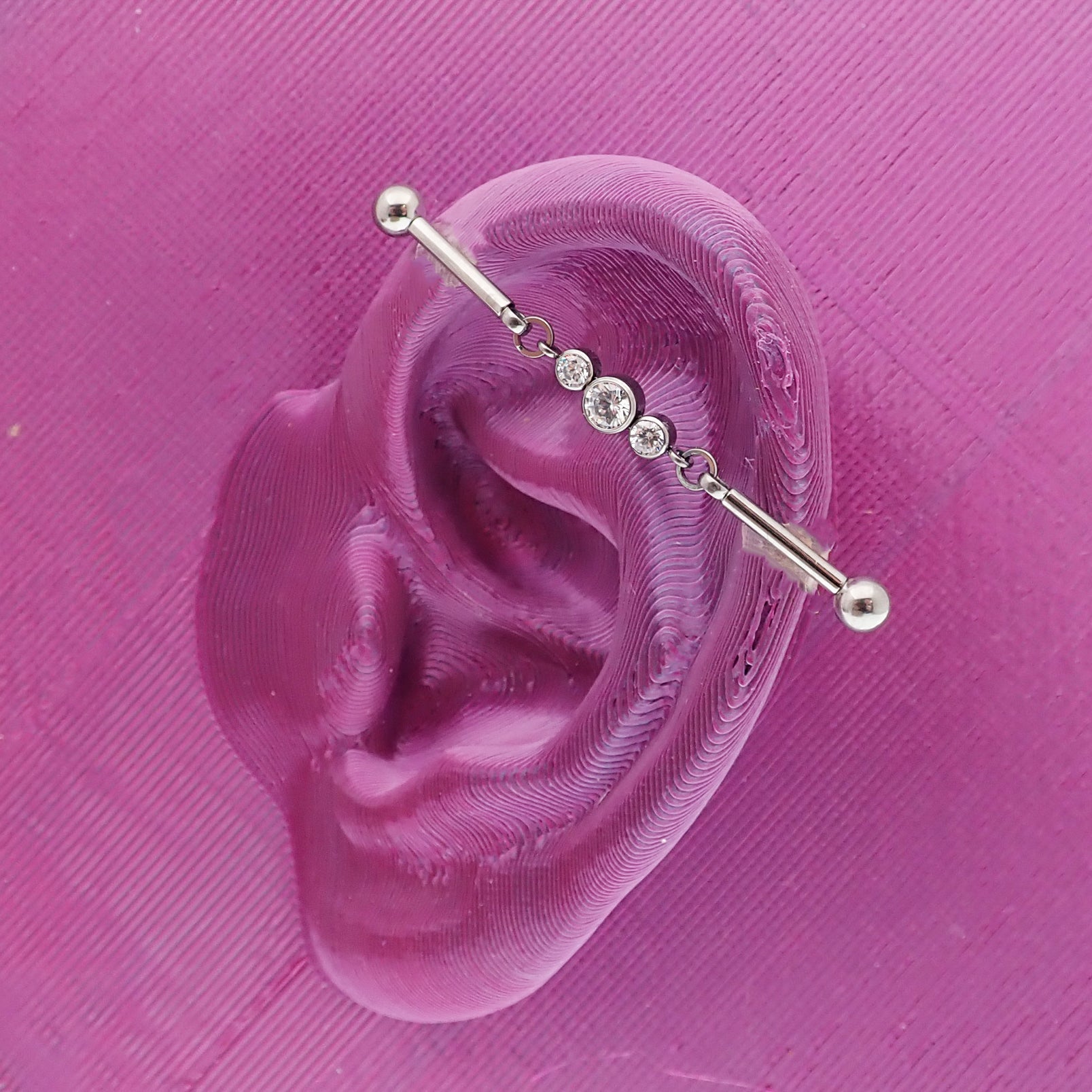 Industrial CZ piercing by Body Clickers featuring a 16g moveable titanium push pin with a 36mm length