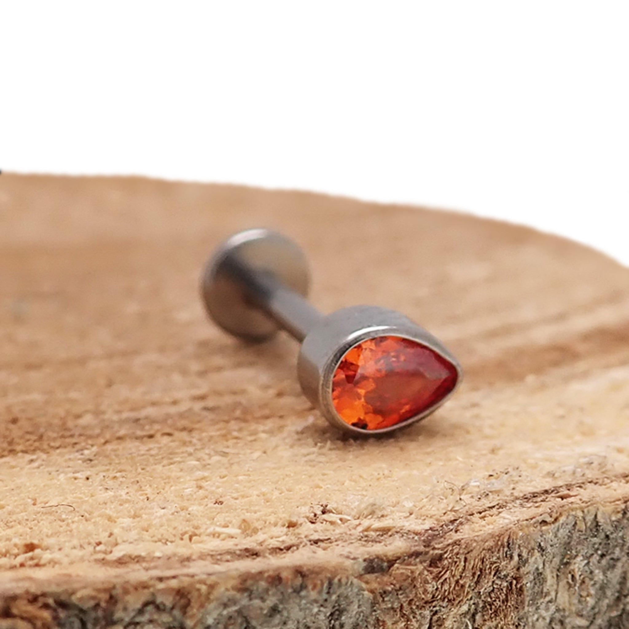 Orange teardrop titanium push fit flatback body jewelry in 14g to 20g from Body Clickers, featuring a sleek teardrop design.