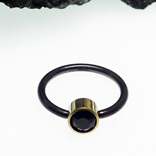 Titanium black and gold CBR onyx ring, 14g, from Body Clickers, displayed with black and gold band and onyx gemstone.