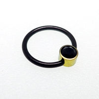 Titanium black and gold CBR onyx ring, 14g, with sleek design and polished finish, by Body Clickers.