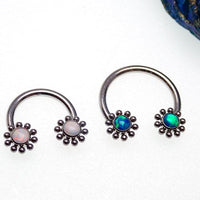 Opal Sun Circular Rings in peacock blue with 16g body jewelry from Body Clickers featuring a round opal design and circular shape.
