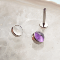 Titanium flatback piercing featuring amethyst and cloudy moonstone gemstones, 14g Body Clickers jewelry, shiny and smooth finish.